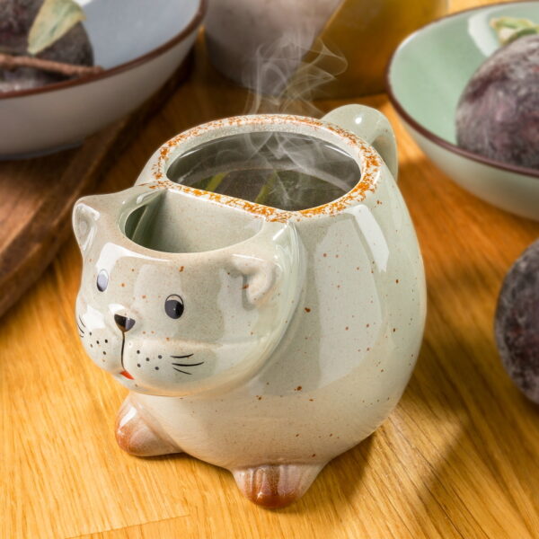 Kubek kot z miejscem na herbatę
